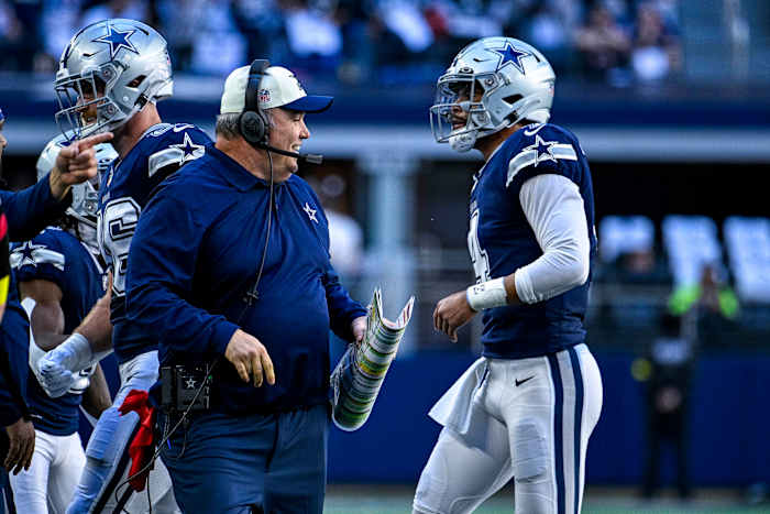 Dallas Cowboys coach Mike McCarthy smiles as quarterback Dak Prescott heads to the sideline.
